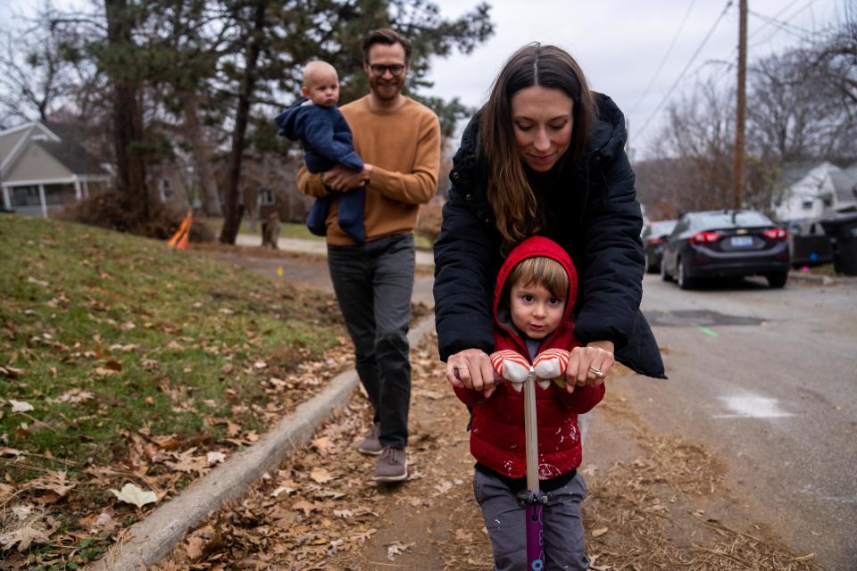 The Donlin family walks down the street near their home Tuesday, Dec. 5, 2023, in Des Moines. After the birth of their second child, Paul, a portion of the umbilical cord was screened in a nonconsensual drug test, which came back positive for cocaine. The family claims the test results were a false positive.