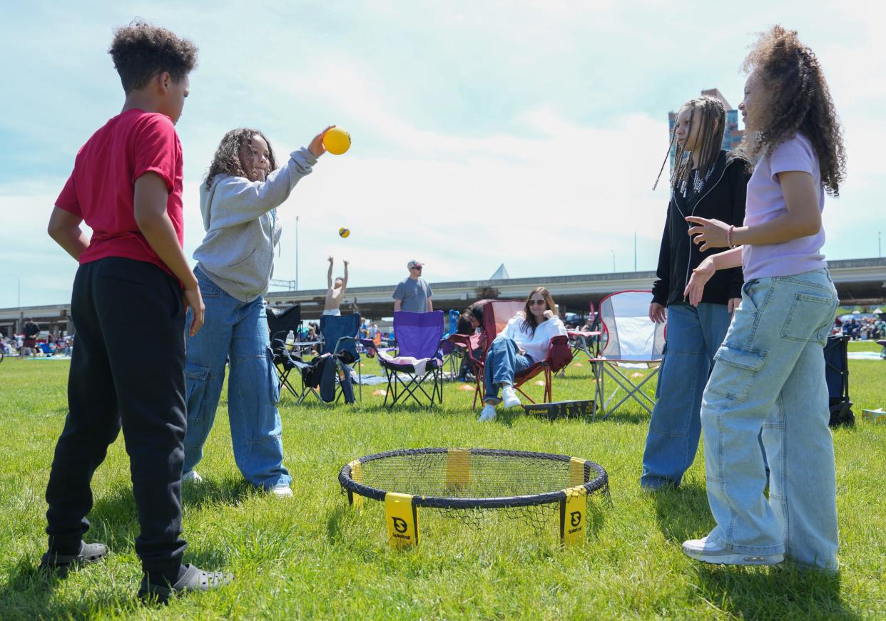 From left: Braelon Burroughs, Aaliyah Floyd, Ayzia Floyd, and Amerrah Floyd play Spikeball before the start of the Thunder Over Louisville airshow on Saturday, April 20, 2024.