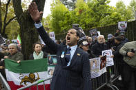 Protesters demonstrate during the global protest against the Iranian regime in front of the Iranian embassy in Bern, Switzerland, Saturday, Oct. 1, 2022. They protest against the death of Mahsa Amini, a woman who died while in police custody in Iran. Mahsa Amini was arrested by Iran's morality police for allegedly violating its strictly-enforced dress code. (Peter Klaunzer/Keystone via AP)