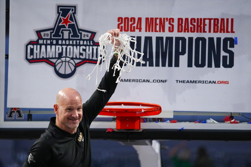 UAB head coach Andy Kennedy holds the net after cutting it while celebrating his team's NCAA college basketball win in the championship of the American Athletic Conference tournament against Temple, Sunday, March 17, 2024, in Fort Worth, Texas. UAB won 85-69. (AP Photo/Julio Cortez)