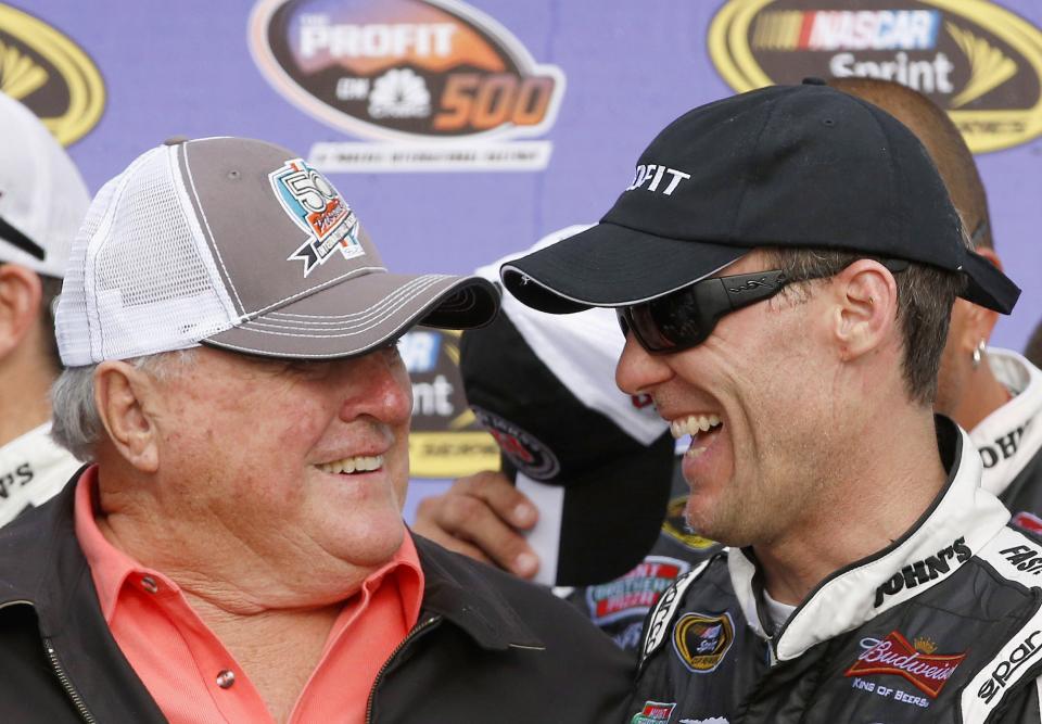 Kevin Harvick, right, laughs with former driver A.J. Foyt in Victory Lane after Harvick own the NASCAR Sprint Cup Series auto race on Sunday, March 2, 2014, in Avondale, Ariz. (AP Photo/Ross D. Franklin)