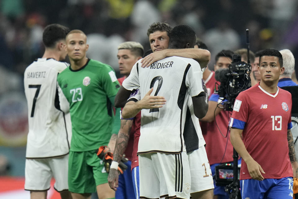 Germany's Thomas Mueller, center, embraces teammate Antonio Ruediger at the end of the World Cup group E soccer match between Costa Rica and Germany at the Al Bayt Stadium in Al Khor , Qatar, Thursday, Dec. 1, 2022. (AP Photo/Hassan Ammar)