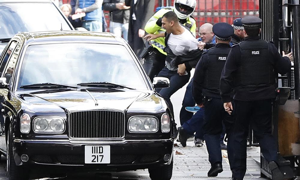 Protesters try to attack the car carrying the King of Bahrain as he arrives at Downing Street in London, October 2016.