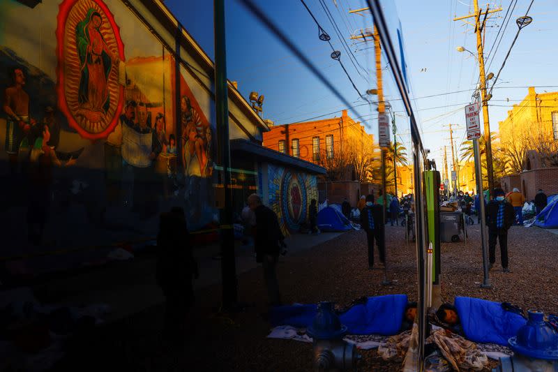 Migrants are reflected on a bus on the day that U.S. President Biden and first lady Jill Biden visit El Paso