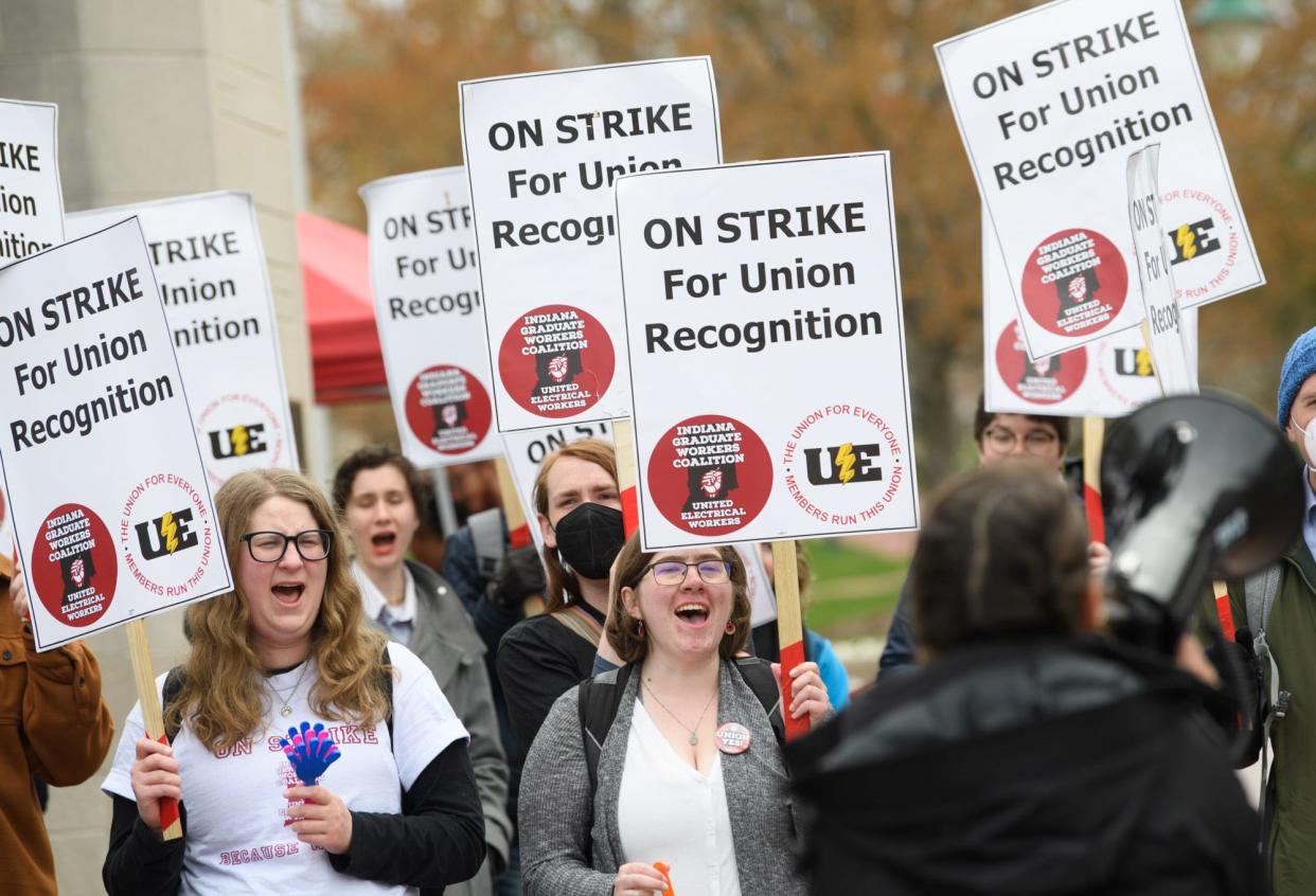 Picketers respond to a call from a speaker supporting the graduate workers strike at the Sample Gates on Wednesday, April 20, 2022.