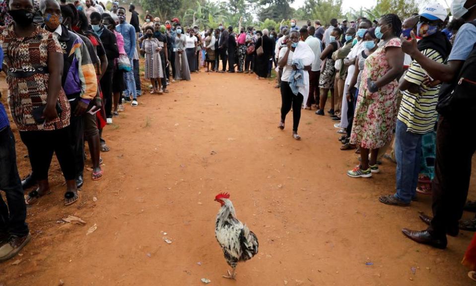 Voters queue outside a voting centre in Kampala.