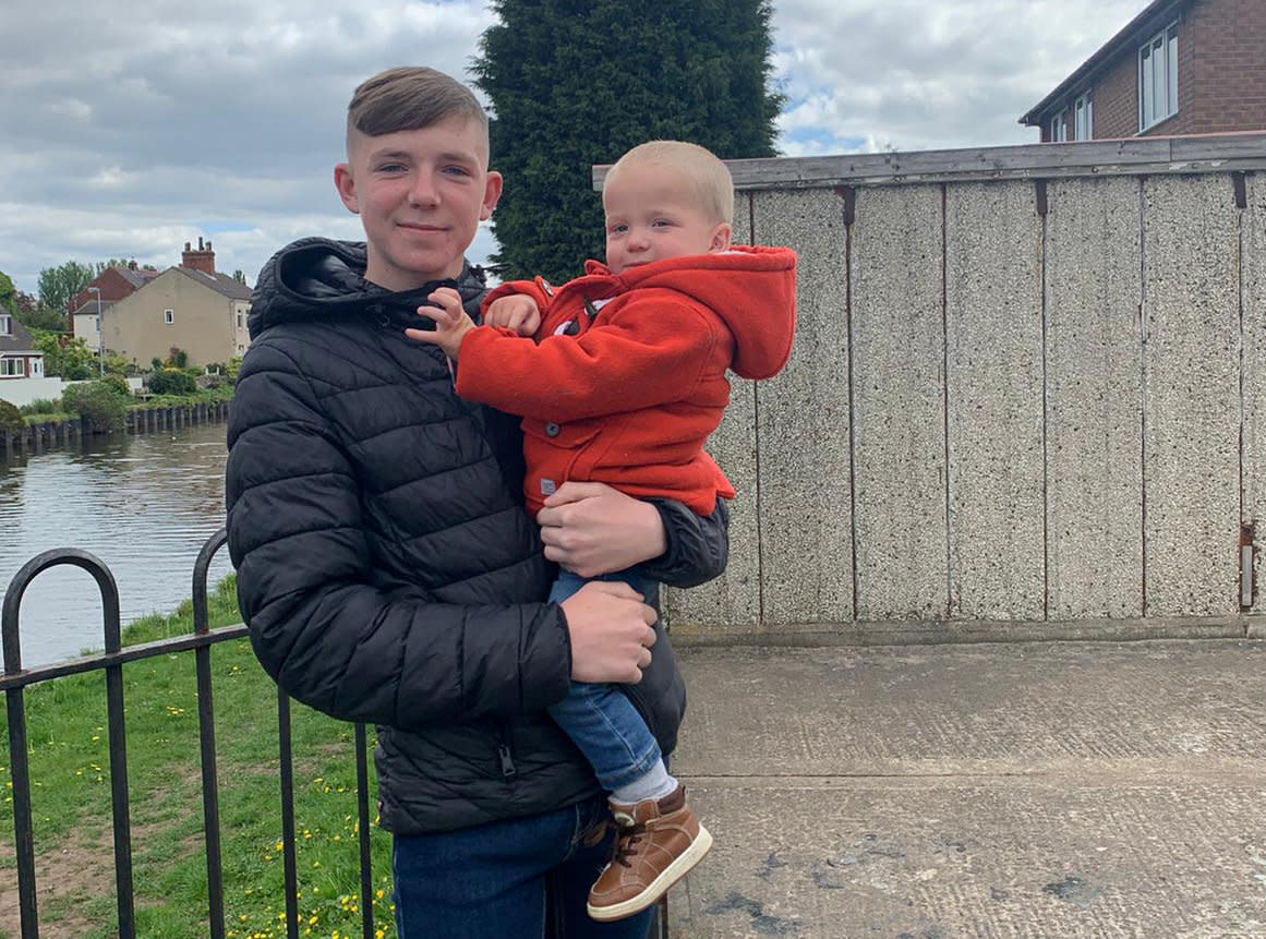 Rylan Ferguson, 15, holding little Reggie after saving him from drowning in a canal (Picture: SWNS)