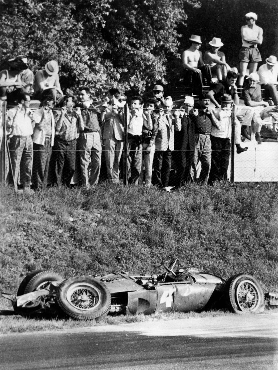 Spectators look at the Ferrari of German driver Wolfgang von Trips after it crashed into the crowd killing 15 people during the Italian Formula One Grand Prix in 1961