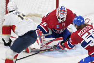 Florida Panthers' Sam Reinhart (13) moves in on Montreal Canadiens goaltender Sam Montembeault as Canadiens' Michael Pezzetta (55) defends during the second period of an NHL hockey game Thursday, March 30, 2023, in Montreal. (Graham Hughes/The Canadian Press via AP)