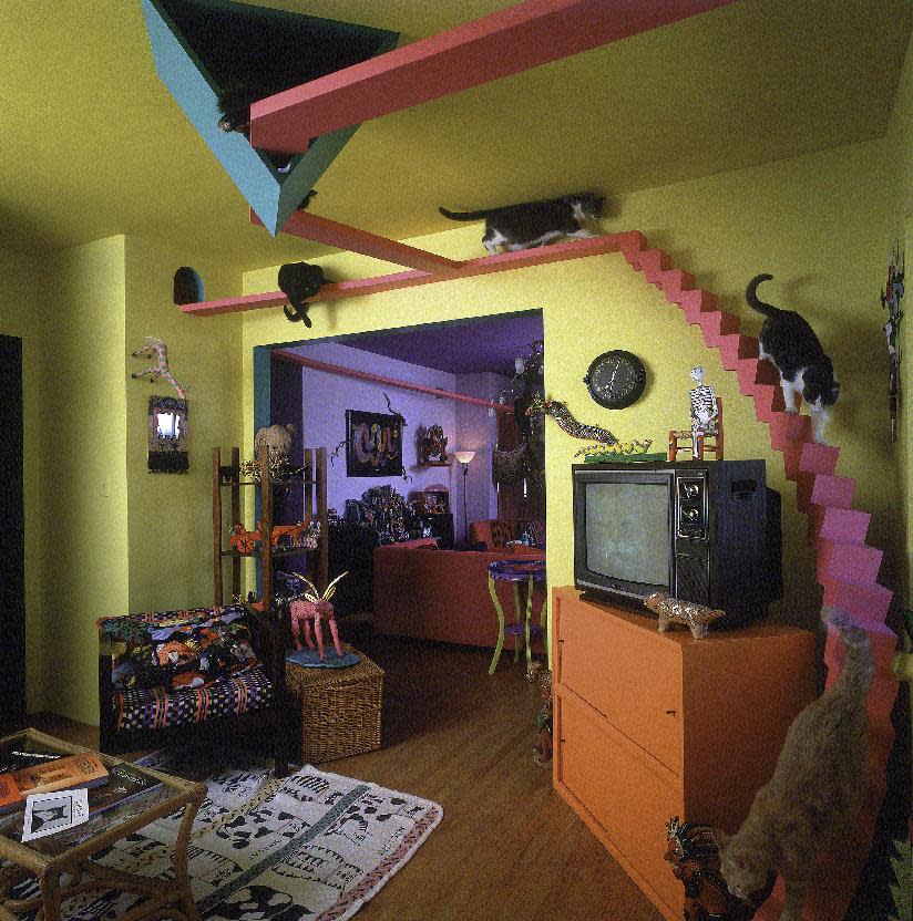 This undated photo released courtesy Bob Walker showing cats walking along a custom stairway in the inside of a home in San Diego Calif. Bob Walker and Frances Mooney moved into the house in 1986 and started converting it into a human-sized cat condo with 140 feet of elevated highway, tunnels, ramps, a spiral staircase, rest areas and scenic vistas. It even had a floor to ceiling scratching post. One improvement seemed to lead to another. (AP Photo/Courtesy Bob Walker)