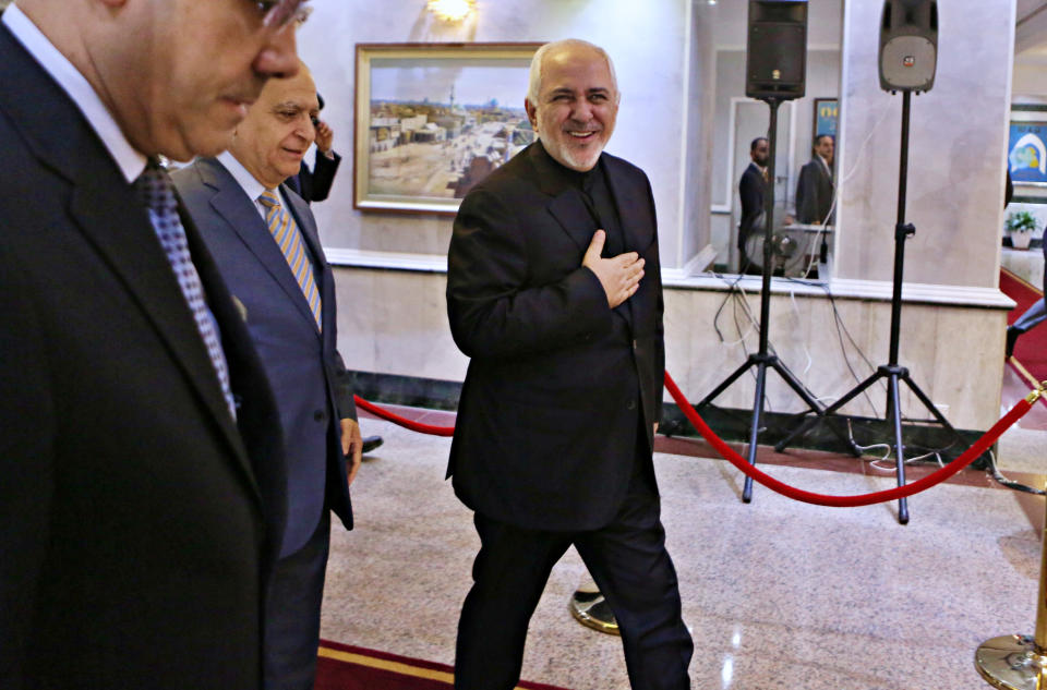Iranian Foreign Minister Mohammad Javad Zarif, center, arrives at the Ministry of Foreign Affairs before his meeting with his Iraqi counterpart Mohamed Alhahkim in Baghdad, Iraq, Sunday, May 26, 2019. (AP Photo/Khalid Mohammed)