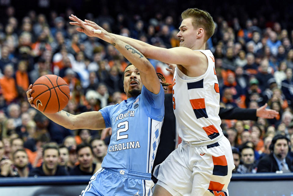 North Carolina guard Cole Anthony (2) is defended by Syracuse guard Buddy Boeheim during the first half of an NCAA college basketball game in Syracuse, N.Y., Saturday, Feb. 29, 2020. (AP Photo/Adrian Kraus)