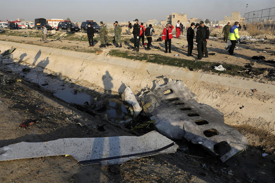 FILE - In this Jan. 8, 2020, file photo, debris is seen from an Ukrainian plane which was shot down, as authorities work at the scene in Shahedshahr, southwest of the capital Tehran, Iran. An Iranian official said Sunday, Aug 23, 2020, that some data, including parts of cockpit conversations, have been retrieved from downed Ukrainian plane. (AP Photo/Ebrahim Noroozi, File)