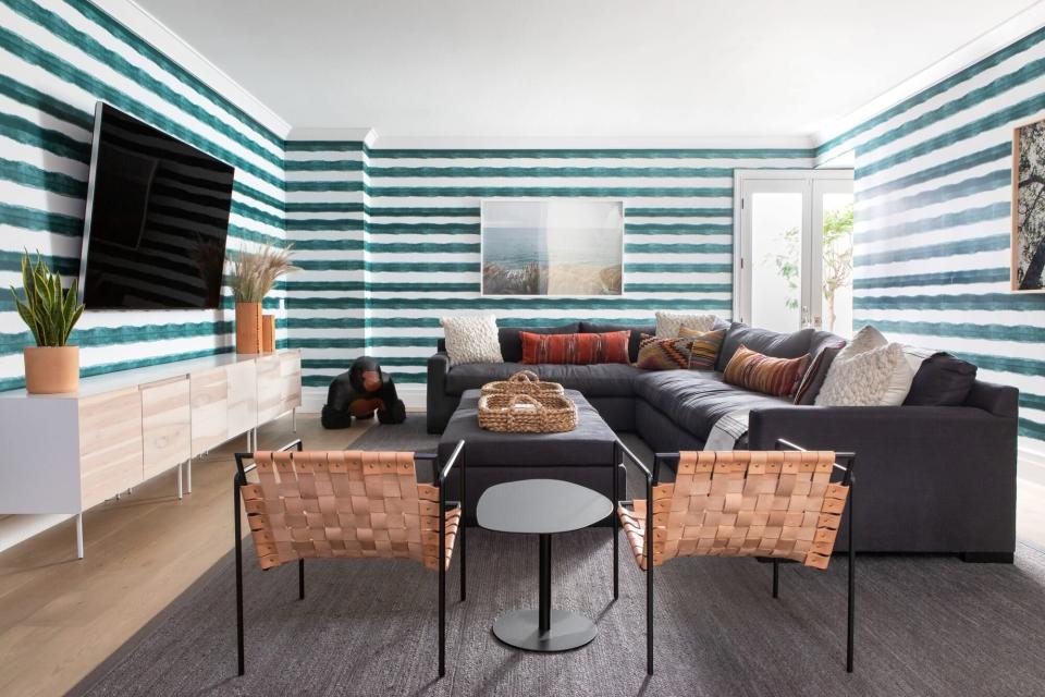 basement with green-and-white striped wallpaper