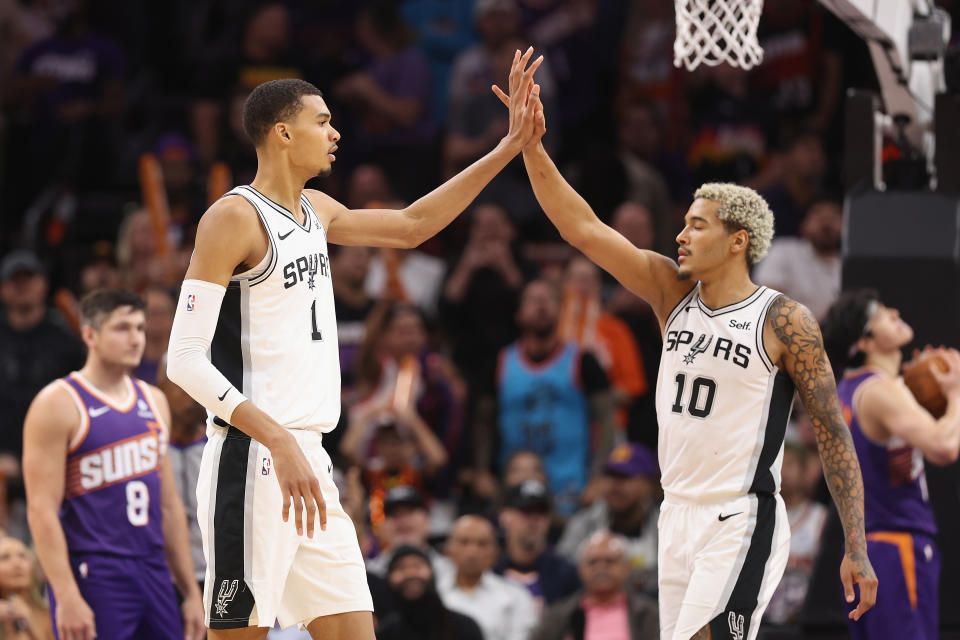 PHOENIX, ARIZONA - NOVEMBER 02: Victor Wembanyama #1 of the San Antonio Spurs high fives Jeremy Sochan #10 during the second half of the NBA game against the Phoenix Suns at Footprint Center on November 02, 2023 in Phoenix, Arizona. The Spurs defeated the Suns 132-121.  NOTE TO USER: User expressly acknowledges and agrees that, by downloading and or using this photograph, User is consenting to the terms and conditions of the Getty Images License Agreement.  (Photo by Christian Petersen/Getty Images)