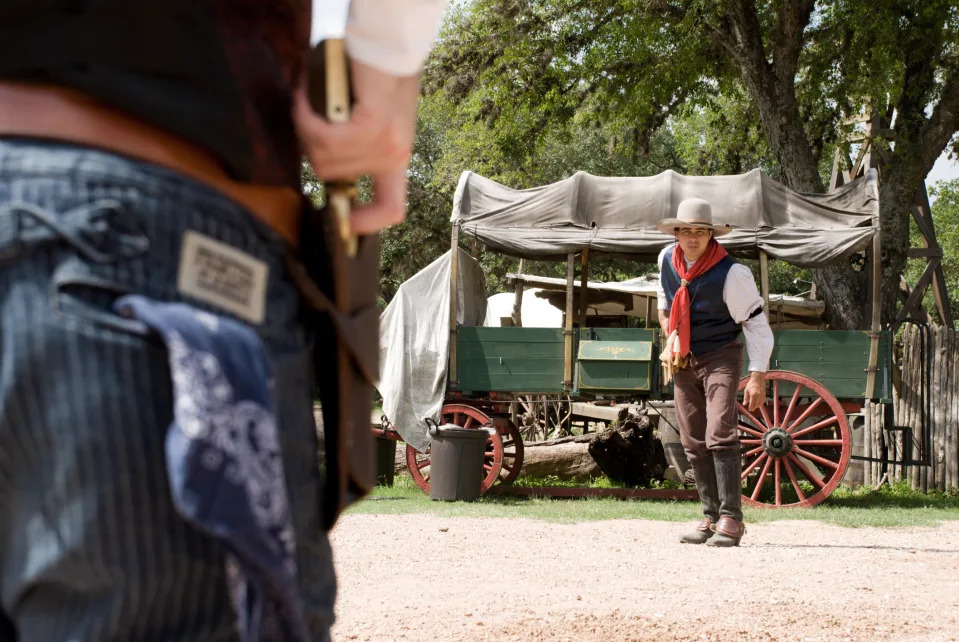 Two men dueling with guns