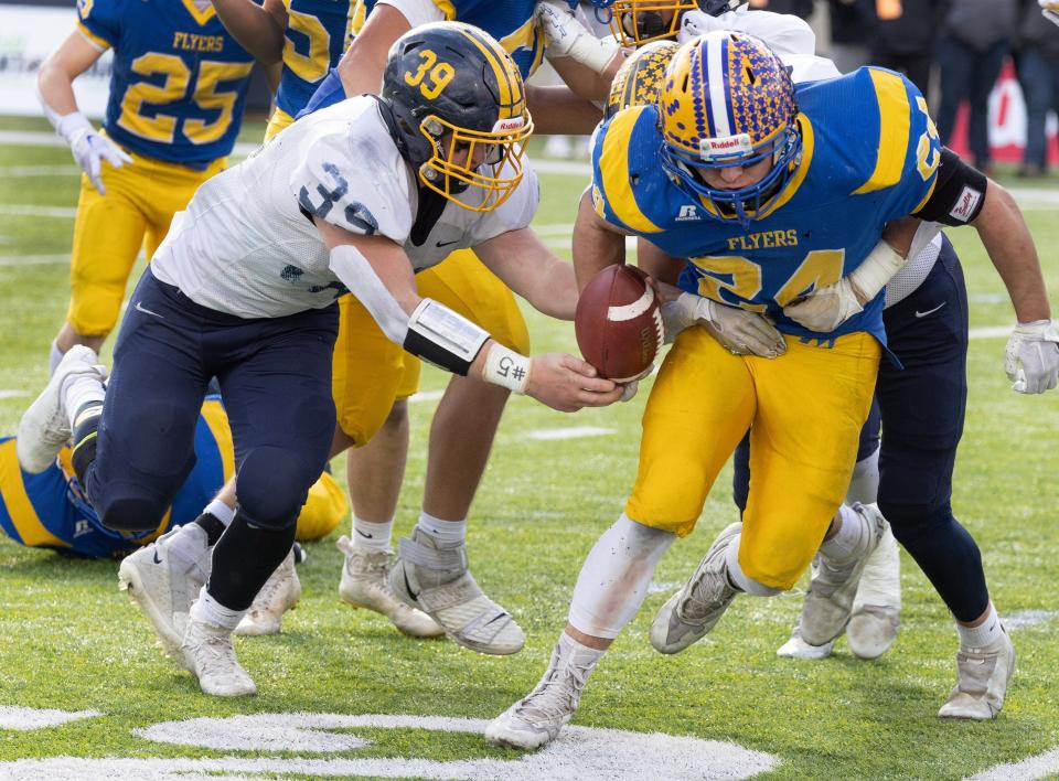 Kirtland’s Macguire Boyd strips the ball from Marion Local's Darren Meier and recovers the fumble in the Division VI state final, Saturday, Dec. 3, 2022. at Tom Benson Hall of Fame Stadium.