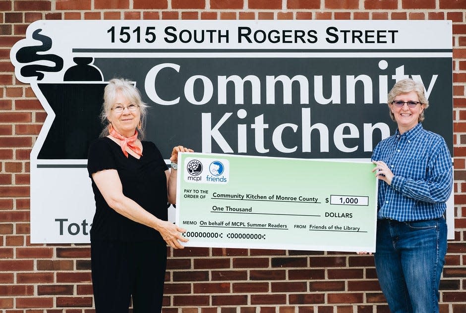 Friends of the Library Board President Patsy Rahn presents a donation of $1,000 to Vicki Pierce, Community Kitchen of Monroe County executive director, in celebration of the library meeting its summer reading registration goal of 1,000 people!.The library’s free all-ages summer reading games continue through July 31. Read for fun, complete activities and attend events to earn prizes. Pick up a game board at the downtown library, Ellettsville Branch or on the Bookmobile. Learn more at mcpl.info/summerreading.