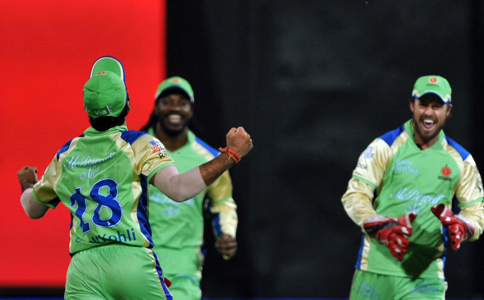 Royal Challengers Bangalore fielder Virat Kohli (L) celebrates the catch to dismiss Mumbai Indians batsman Sachin Tendulkar with teammates A B De Villiers (R) and Chrys Gayle (C) during the IPL Twenty20 cricket match between Royal Challengers Bangalore and Mumbai Indians at the M. Chinnaswamy Stadium in Bangalore on May 14, 2012.   RESTRICTED TO EDITORIAL USE. MOBILE USE WITHIN NEWS PACKAGE.   AFP PHOTO/Manjunath KIRAN        (Photo credit should read Manjunath Kiran/AFP/GettyImages)