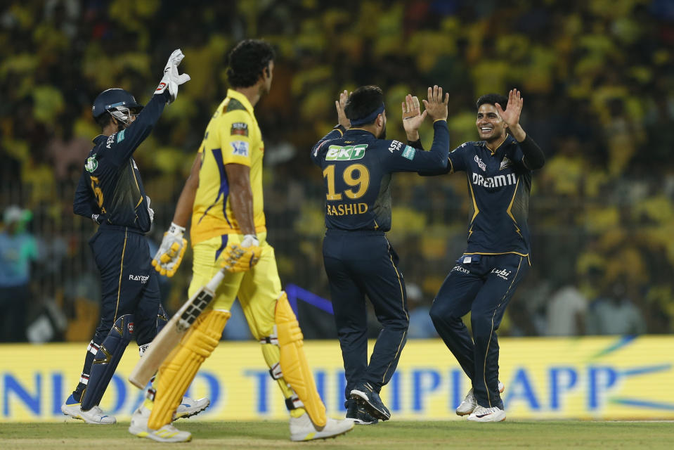 Gujarat Titans' captain Shubman Gill celebrates the wicket of Chennai Super Kings' Shivam Dube with Rashid Khan during the Indian Premier League cricket tournament between between Chennai Super Kings and Gujarat Titans, in Chennai, India, Tuesday, March 26, 2024. (AP Photo/R. Parthibhan)