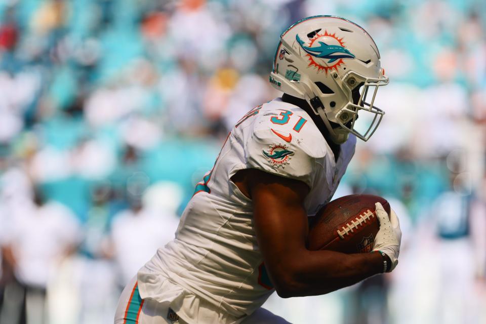 September 8, 2024; Miami Gardens, Florida, USA; Raheem Mostert (31), running back of the Miami Dolphins, runs with the ball against the Jacksonville Jaguars in the third quarter at Hard Rock Stadium. Mandatory Credit: Sam Navarro-Imagn Images ORG XMIT: IMAGN-880878 ORIG FILE ID: 20240908_szo_na2_0271.JPG