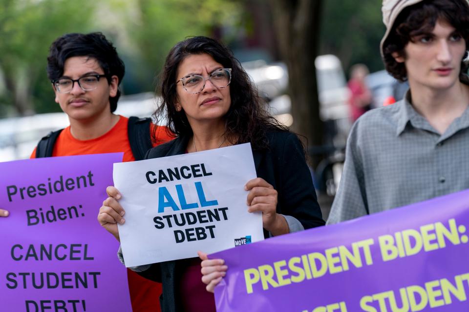 Rep. Rashida Tlaib, D-Mich., center, and her son Adam, left, attend a rally to urge President Joe Biden to cancel student debt near the White House in Washington on July 27.