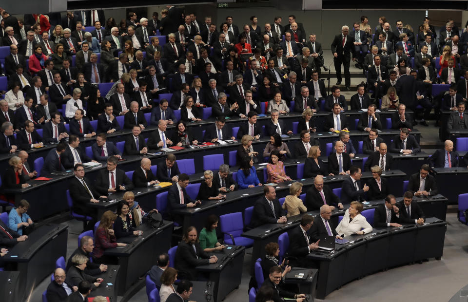 FILE - In this Wednesday, March 14, 2018 file photo, German Chancellor Angela Merkel, front row center, sits in the first row in front of the lawmakers of her center-right Christian Union block when Germany's parliament Bundestag meets to elect Angela Merkel for a fourth term as chancellor in Berlin, Germany. Before Merkel took office in 2005, 23 percent of federal lawmakers for her center-right Union bloc were women and today, the figure is 19.9 percent. (AP Photo/Markus Schreiber, File)