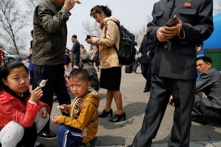 FILE PHOTO: People enjoy ice-cream in central Pyongyang, North Korea April 16, 2017. REUTERS/Damir Sagolj/File Photo