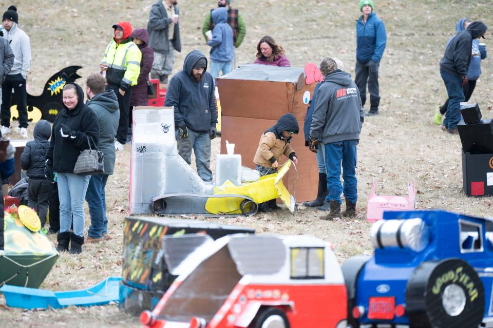 Competitors make final preparations before the Festivus Cardboard Sled Competition at Leila Arboretum on Saturday, Feb. 10, 2024.