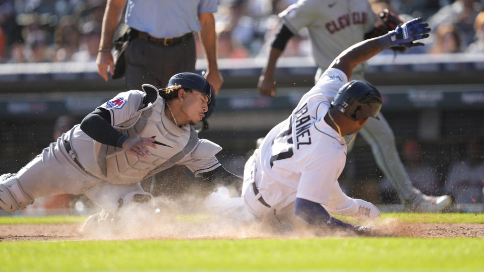 Detroit Tigers' Andy Ibanez (77) as Cleveland Guardians catcher Bo Naylor (23) loses the ball attempting to make the tag in the seventh inning of a baseball game, Saturday, Sept. 30, 2023, in Detroit. (AP Photo/Paul Sancya)