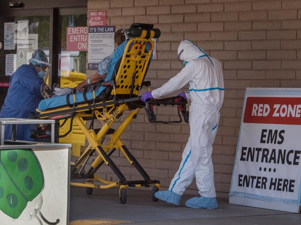 A patient is taken from an ambulance to the emergency room of a hospital in the Navajo Nation town of Tuba City during the 57-hour curfew, imposed to try to stop the spread of the Covid-19 virus: (2020 Getty Images)