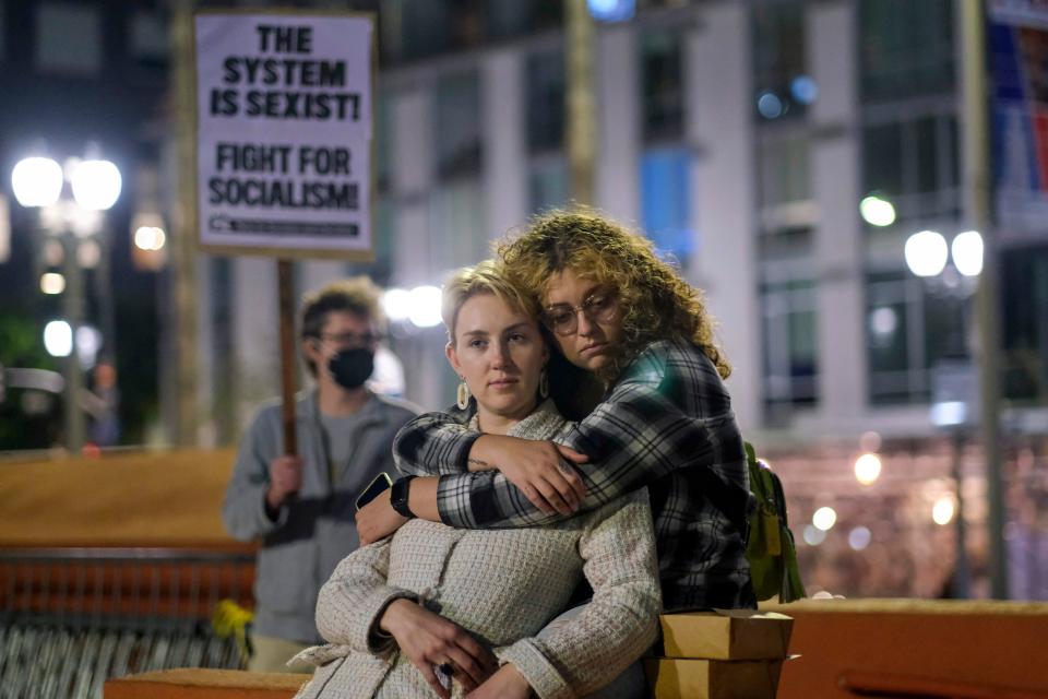 Hunter Kay, right, 27, hugs her friend Taisiia Work, 23, as demonstrators gather at Pershing Square after protesting outside of the U.S. Courthouse in response to a leaked draft of the Supreme Court's opinion to overturn Roe v. Wade, in Los Angeles on March 3, 2022.