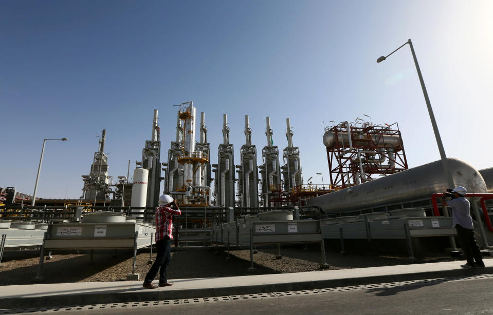 Photographers take pictures inside the Shams 1, Concentrated Solar power (CSP) plant, in al-Gharibiyah district on the outskirts of Abu Dhabi, on March 17, 2013 during the inauguration of the facility. Oil-rich Abu Dhabi officially opened the world's largest Concentrated Solar Power (CSP) plant, which cost $600 million to build and will provide electricity to 20,000 homes. (MARWAN NAAMANI/AFP/Getty Images)