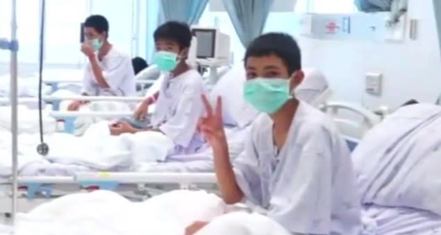 One of the rescued teens gives a “victory” sign from hospital. Source: AP/Thai Government PDR