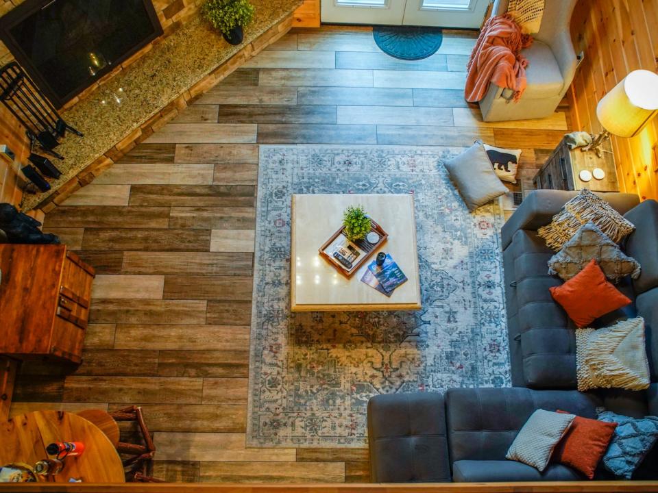 Aerial shot of living room,  Joey Hadden, "I spent 2 nights in a cozy A-frame cabin for the first time while visiting the Great Smoky Mountains"
