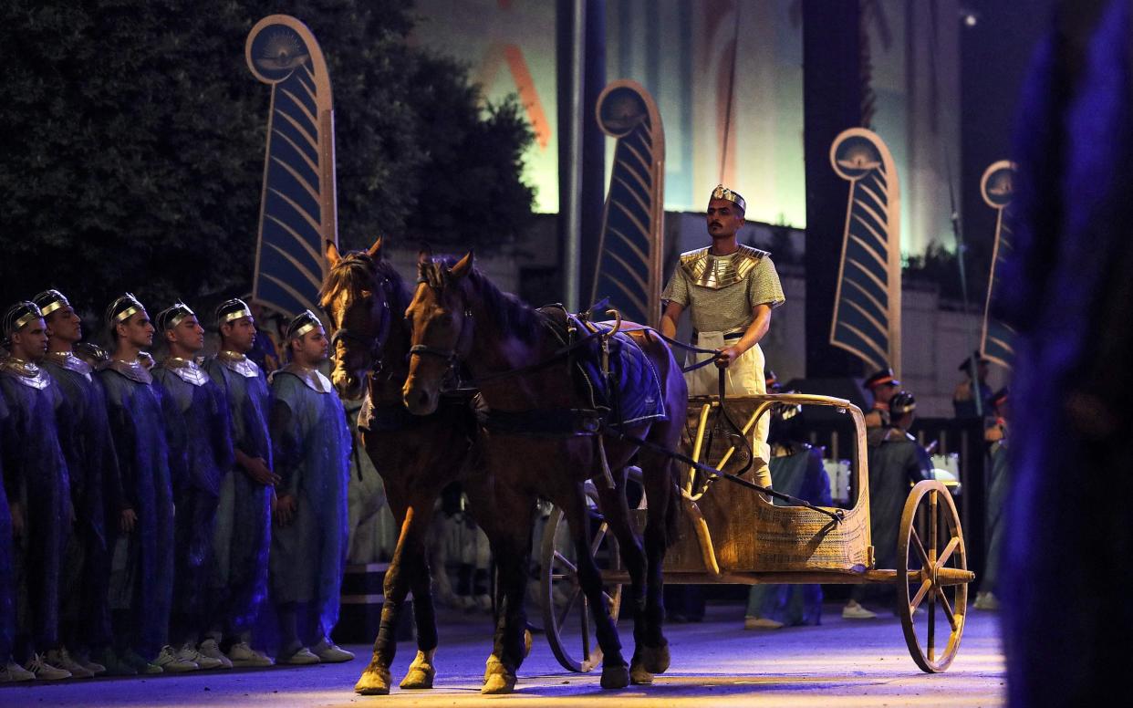 A performer rides a chariot at the start of the parade of 22 ancient royal mummies departing from the Egyptian Museum in Cairo's Tahrir Square - MAHMOUD KHALED/AFP