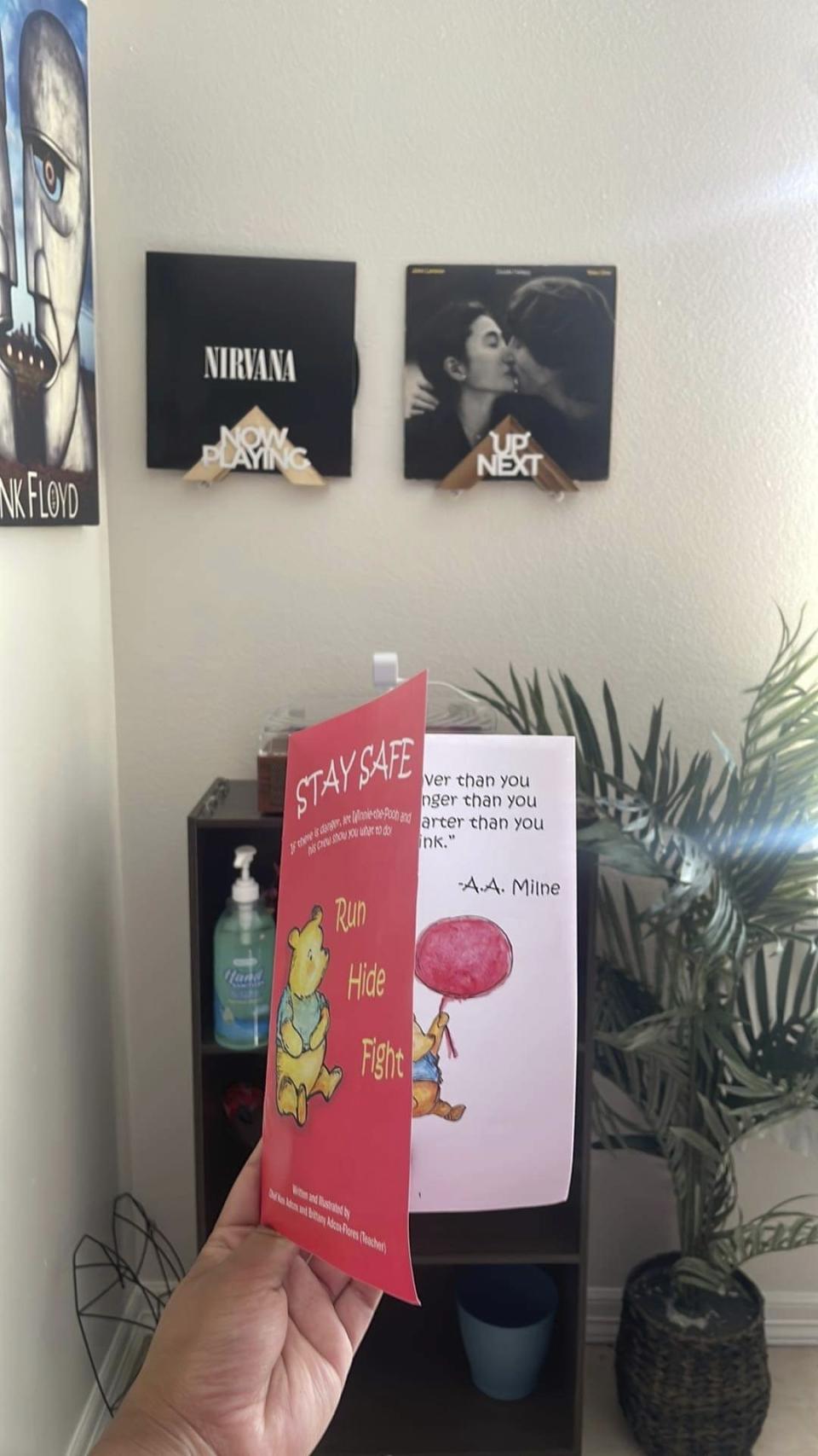 Cindy Campos holds the book "Stay Safe" in Dallas. Campos' 5-year-old son was so excited about the Winnie the Pooh book he got at school that he asked her to read it with him as soon as he got home. But her heart sank when she realized it was a tutorial about what to do when “danger is near,” advising kids to lock the doors, turn off the lights and quietly hide. (Cindy Campos via AP)