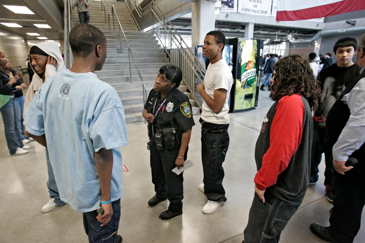 Milwaukee Police officer GiGi Shuttlesworth, who is stationed at Bradley Tech High School, talks with students going to lunch in March 2007.