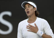 Spain's Garbine Muguruza celebrates after defeating Shelby Rogers of the U.S. in their first round singles match at the Australian Open tennis championship in Melbourne, Australia, Tuesday, Jan. 21, 2020. (AP Photo/Lee Jin-man)