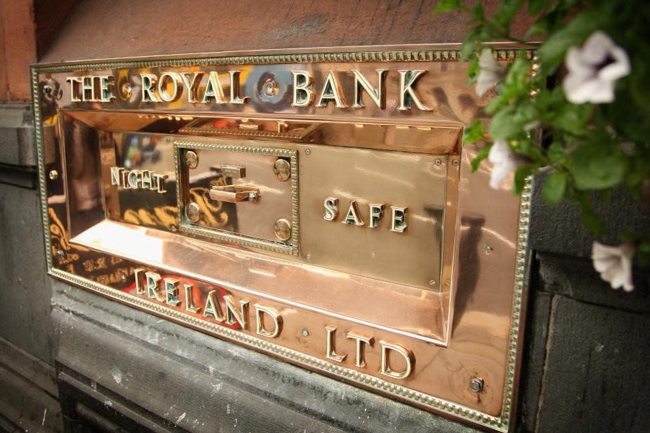 Flowers grow next to the Royal Bank of Ireland night safe in Dublin.