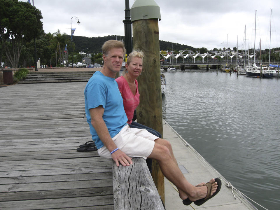 In this undated photo provided by Robin Wright, Ricky Wright and wife Robin Wright sit at a dock in the New Zealand port of Whangarei, where the wooden sailboat Nina was moored in 2013. The couple have continued to search for their daughter Danielle, who was aboard the schooner and went missing at sea in the South Pacific more than eight months ago. (AP Photo/Courtesy of Robin Wright) EDITORIAL USE ONLY