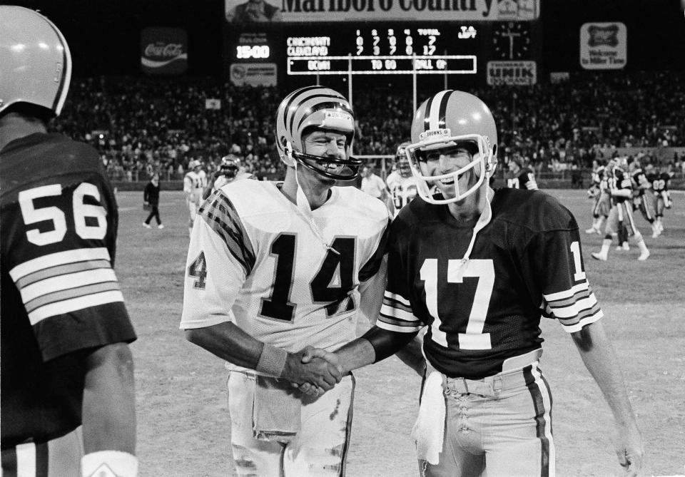 Cincinnati Bengals quarterback Ken Anderson (14) smiles as he congratulates Cleveland Browns' quarterback Brian Sipe (17) on his teams 17-7 victory over the Bengals in a game played in Cleveland on Sept. 15, 1983.