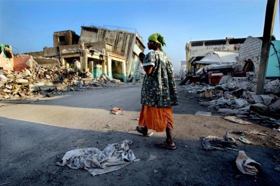 A woman walks down a devastated block in downtown Port-au-Prince nearly a month after a 7.0 earthquake hit Haiti on Jan. 12, 2010.