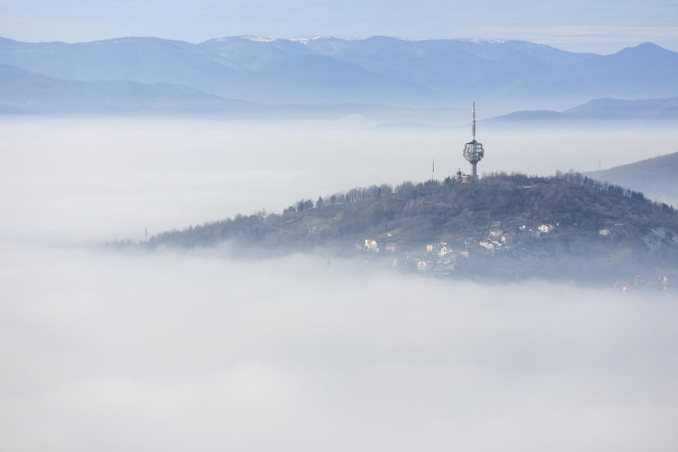 A TV tower is seen on a hill as smog covers Sarajevo, Bosnia, Wednesday, Dec. 20, 2023. According to a Swiss air quality company Sarajevo is one of the most polluted cities in the world. (AP Photo/Armin Durgut)