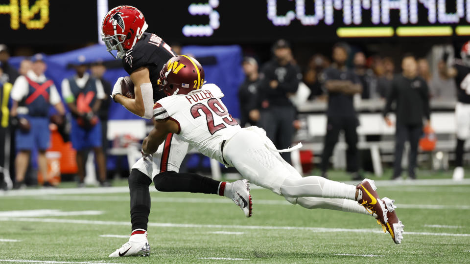 Atlanta Falcons wide receiver Drake London (5) makes the catch against Washington Commanders cornerback Kendall Fuller (29) during the first half of an NFL football game, Sunday, Oct. 15, 2023, in Atlanta. (AP Photo/Butch Dill)