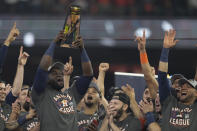 Houston Astros designated hitter Yordan Alvarez holds the trophy after their win against the Boston Red Sox in Game 6 of baseball's American League Championship Series Friday, Oct. 22, 2021, in Houston. The Astros won 5-0, to win the ALCS series in game six. (AP Photo/Tony Gutierrez)