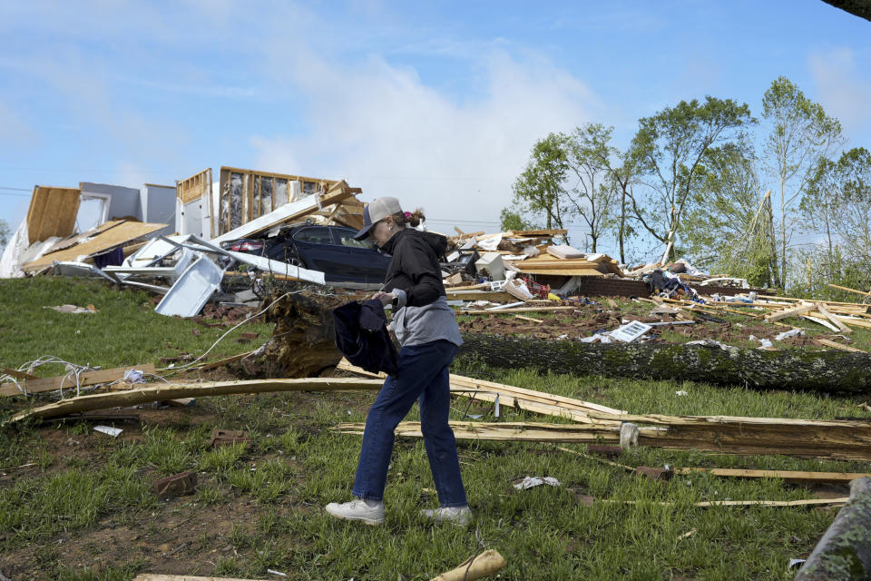 Valerie Bernhardt searches for belongings outside her stormed damaged home Thursday, May 9, 2024, in Columbia, Tenn. Severe storms tore through the central and southeast U.S., Wednesday, spawning damaging tornadoes, producing massive hail, and killing several people in Tennessee. (AP Photo/George Walker IV)