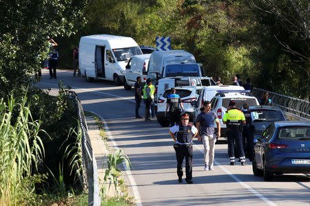 Catalan Mossos d'Escuadra vans are parked along a road near the place where Younes Abouyaaqoub, the man suspected of driving the van that killed 13 people in Barcelona last week, was killed by police in Sant Sadurni d'Noia, Spain, August 21, 2017. REUTERS/Albert Gea