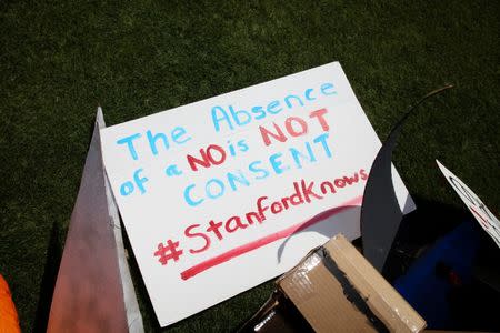 A hand-made sign referencing consent in relation to sexual assault lays on the ground at the Stanford University commencement ceremony in Palo Alto, California, June 12, 2016. REUTERS/Elijah Nouvelage