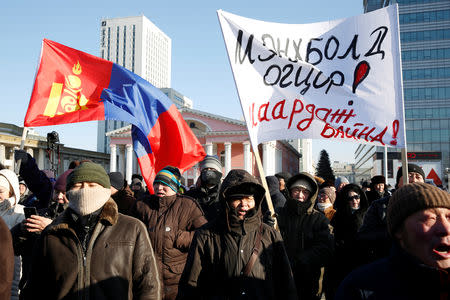 Protesters attend a demonstration to demand the resignation of Mongolia's parliamentary speaker Enkhbold Miyegombo, at Sukhbaatar Square in Ulaanbaatar, Mongolia December 27, 2018. The sign reads, "We demand Enkhbold to resign!" REUTERS/B. Rentsendorj?